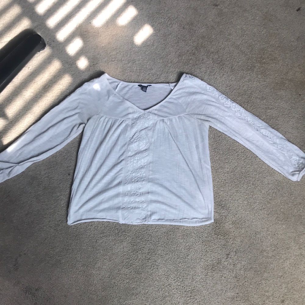 White shirt with patterns going down the center